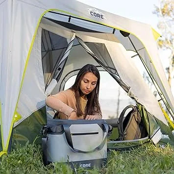 Family using CORE insulated cooler at beach picnic gathering outdoors