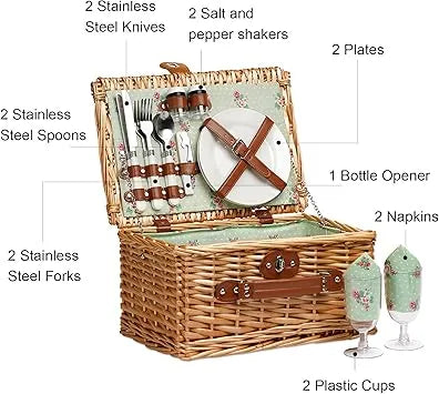 Couple enjoying outdoor picnic with open handmade willow basket on grass